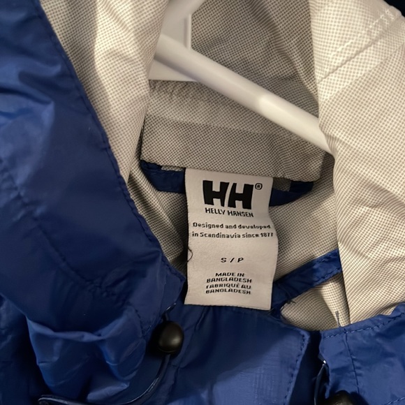 A small blue Helly Hansen rain jacket - Picture 2 of 3